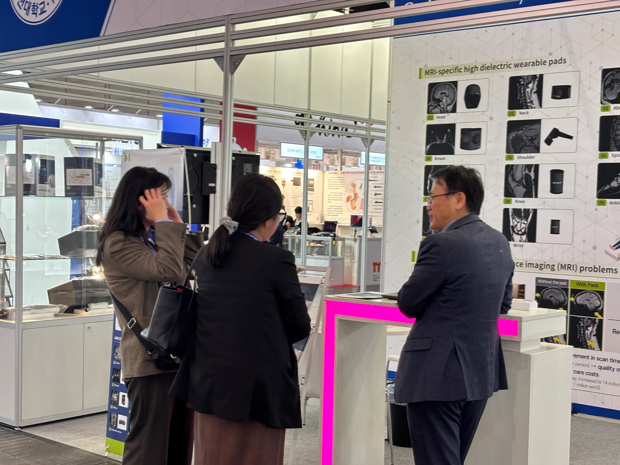 MTechLab representative demonstrating the exhibition booth to MEDICA 2025 visitors