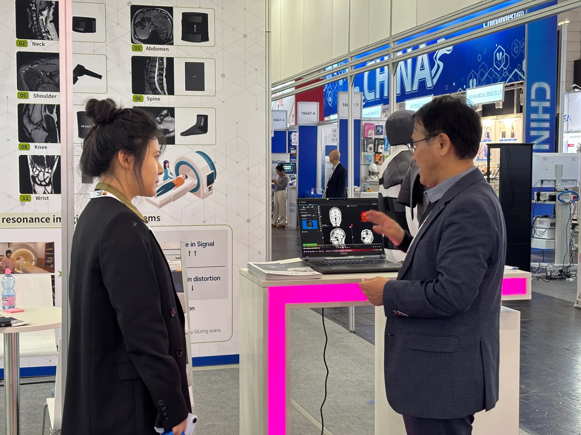 MTechLab representative explaining the wearable MRI dielectric pad display