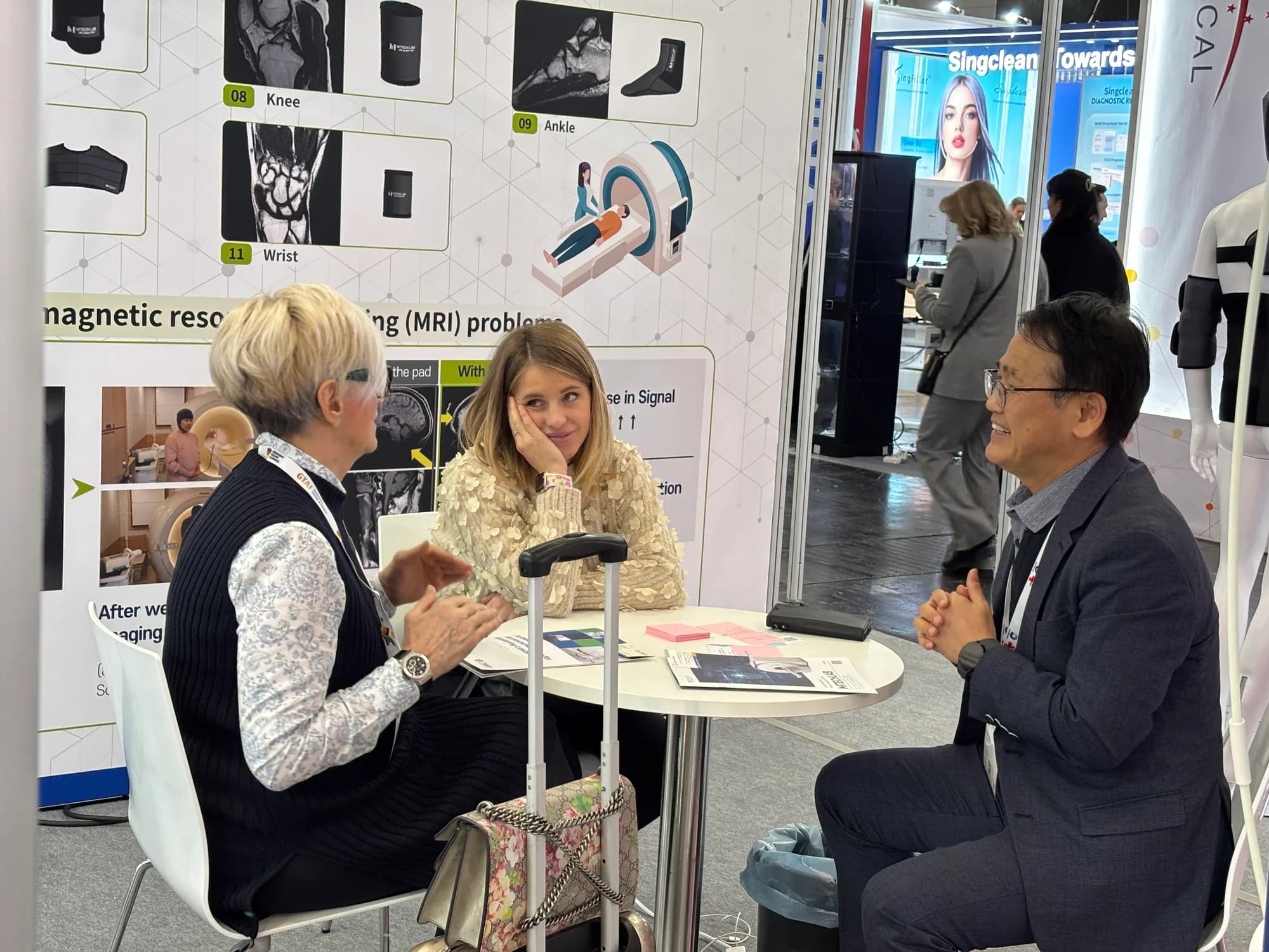 MTechLab representative in discussion with two exhibition visitors