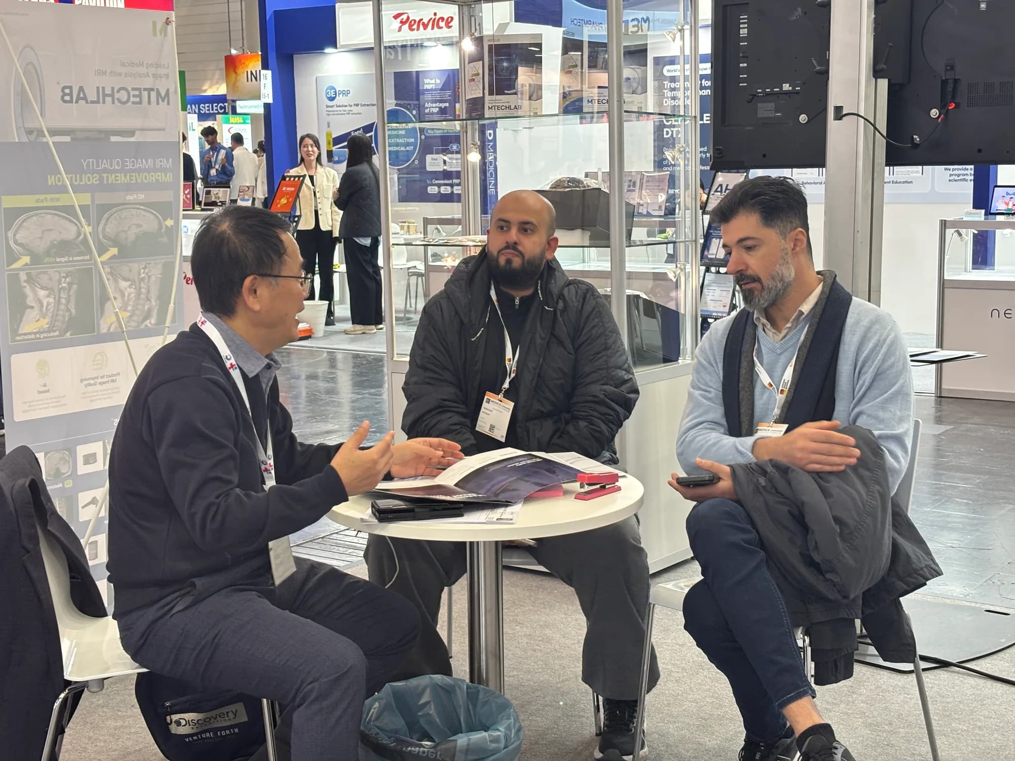 Seated international business meeting at the MTechLab booth