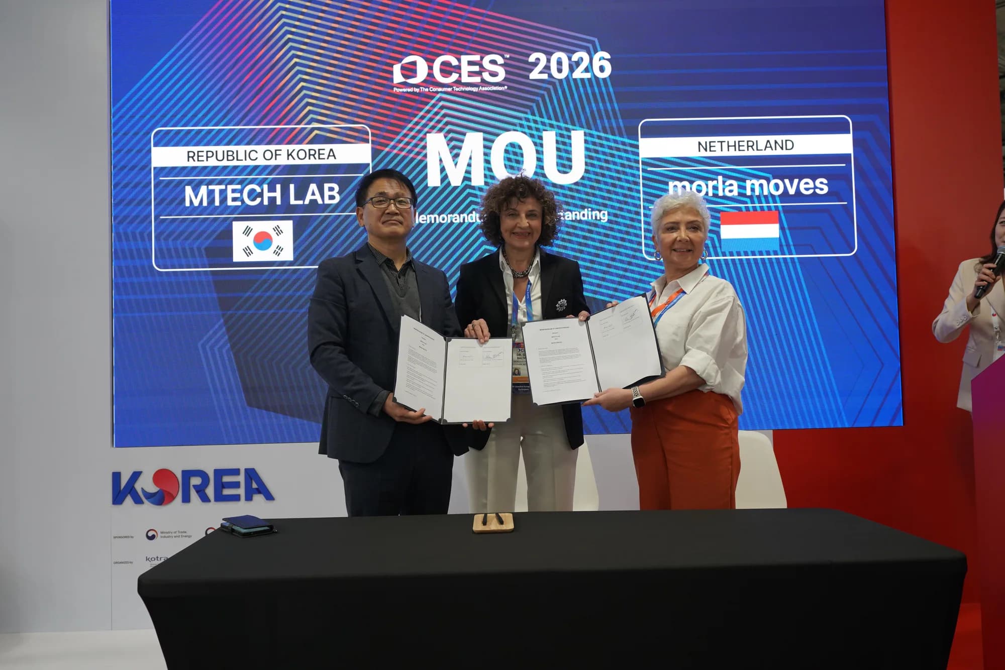 Three MTechLab and MORLA Moves representatives presenting the signed partnership agreement