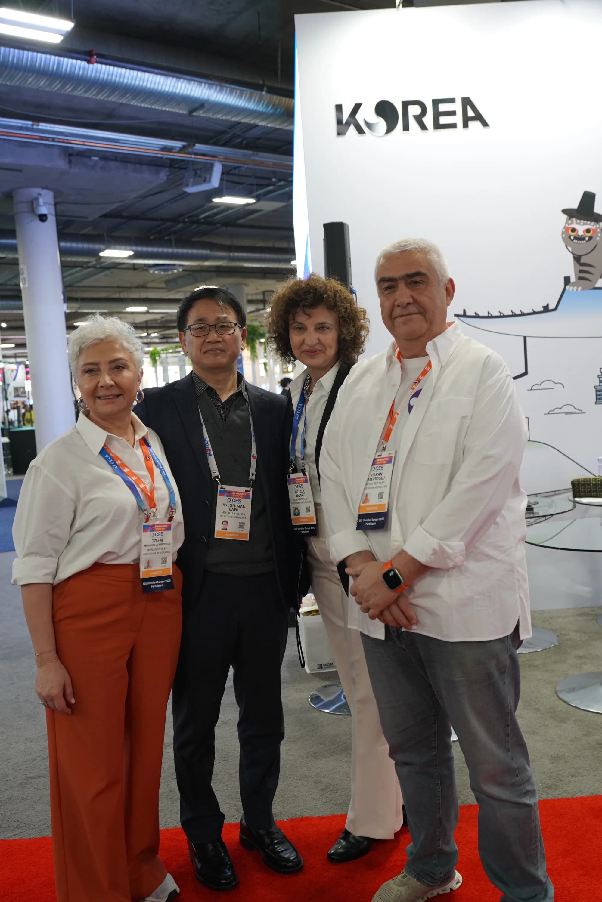 Four representatives meeting at the MTechLab exhibition booth